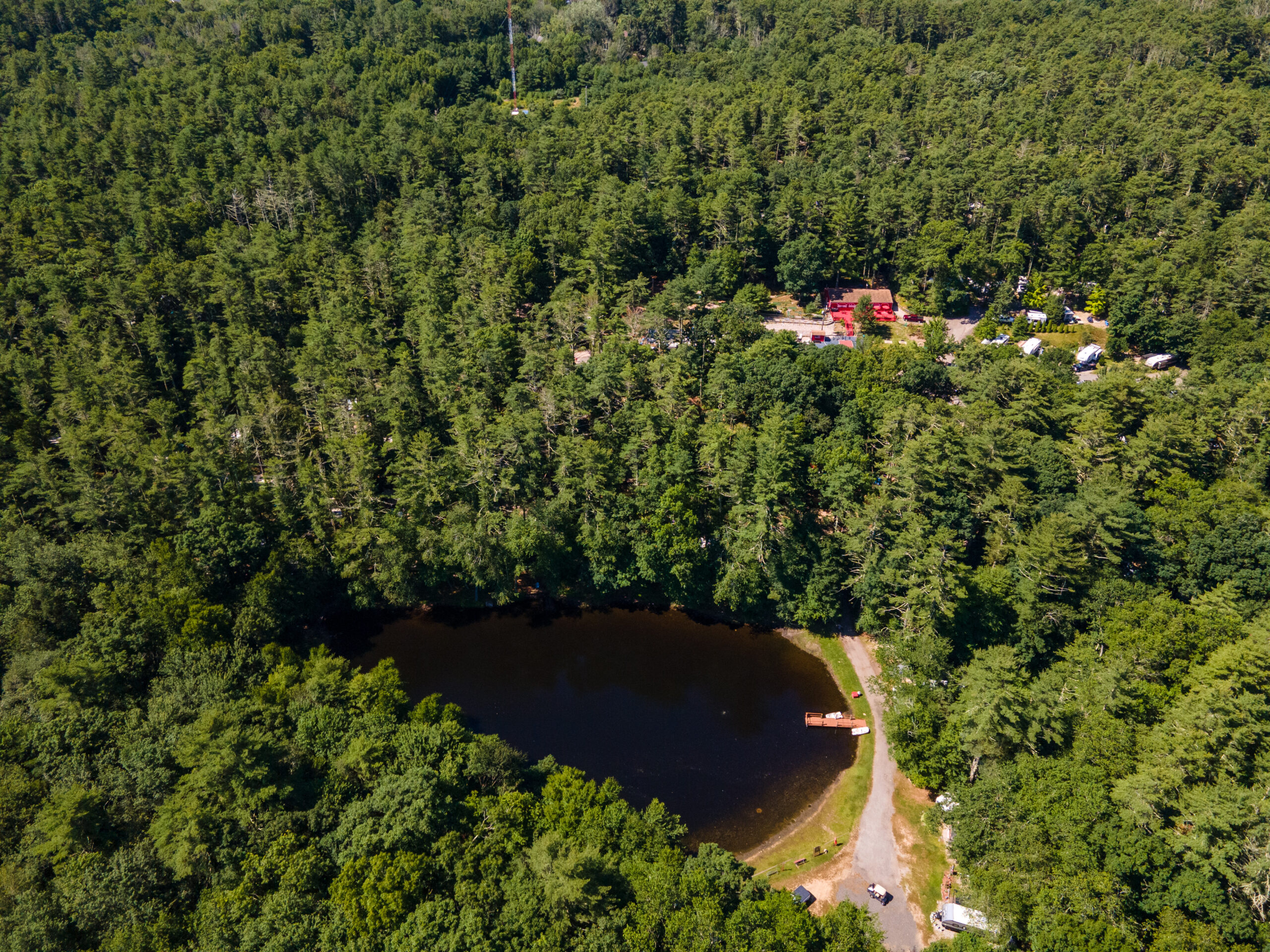 Whispering Pines Campground in Hope Valley Rhode Island Aerial view of wooded campground scenery at Whispering Pines Campground